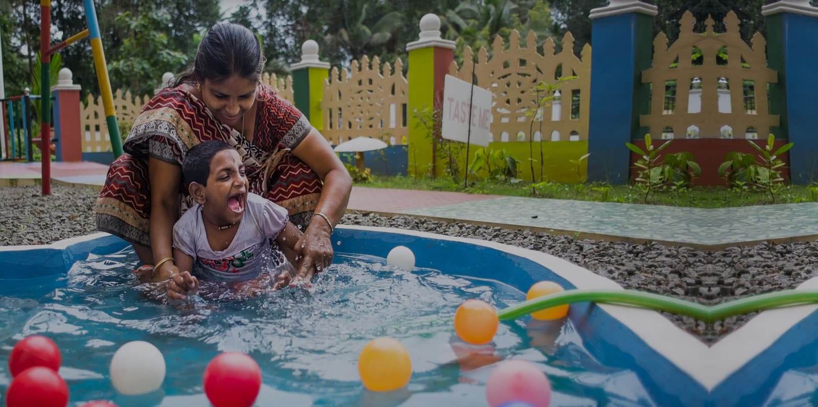 Teacher and a boy with deafblindness in sensory session in waterpool